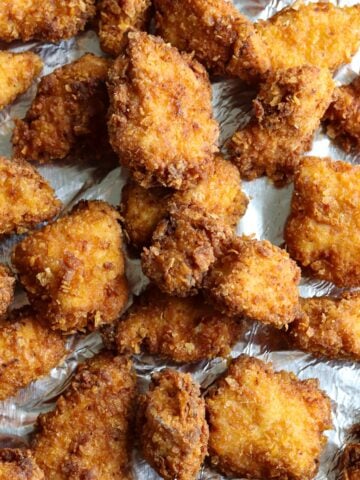 Crispy cornflake coated fried chicken nuggets fresh out of the the skillet.