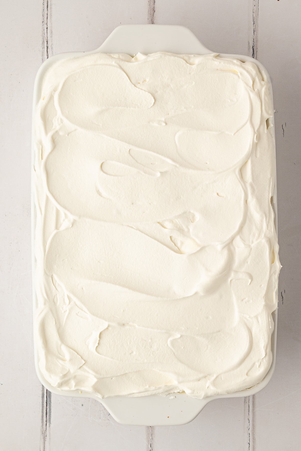 Banana pudding in an 11x7 casserole dish topped with Cool-Whip.