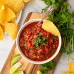 Close-up of vibrant, fresh Texas restaurant style blender salsa in a serving bowl.