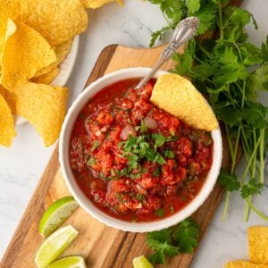 Close-up of vibrant, fresh Texas restaurant style blender salsa in a serving bowl.