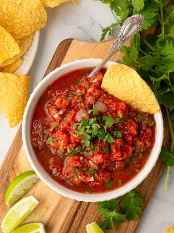 Close-up of vibrant, fresh Texas restaurant style blender salsa in a serving bowl.