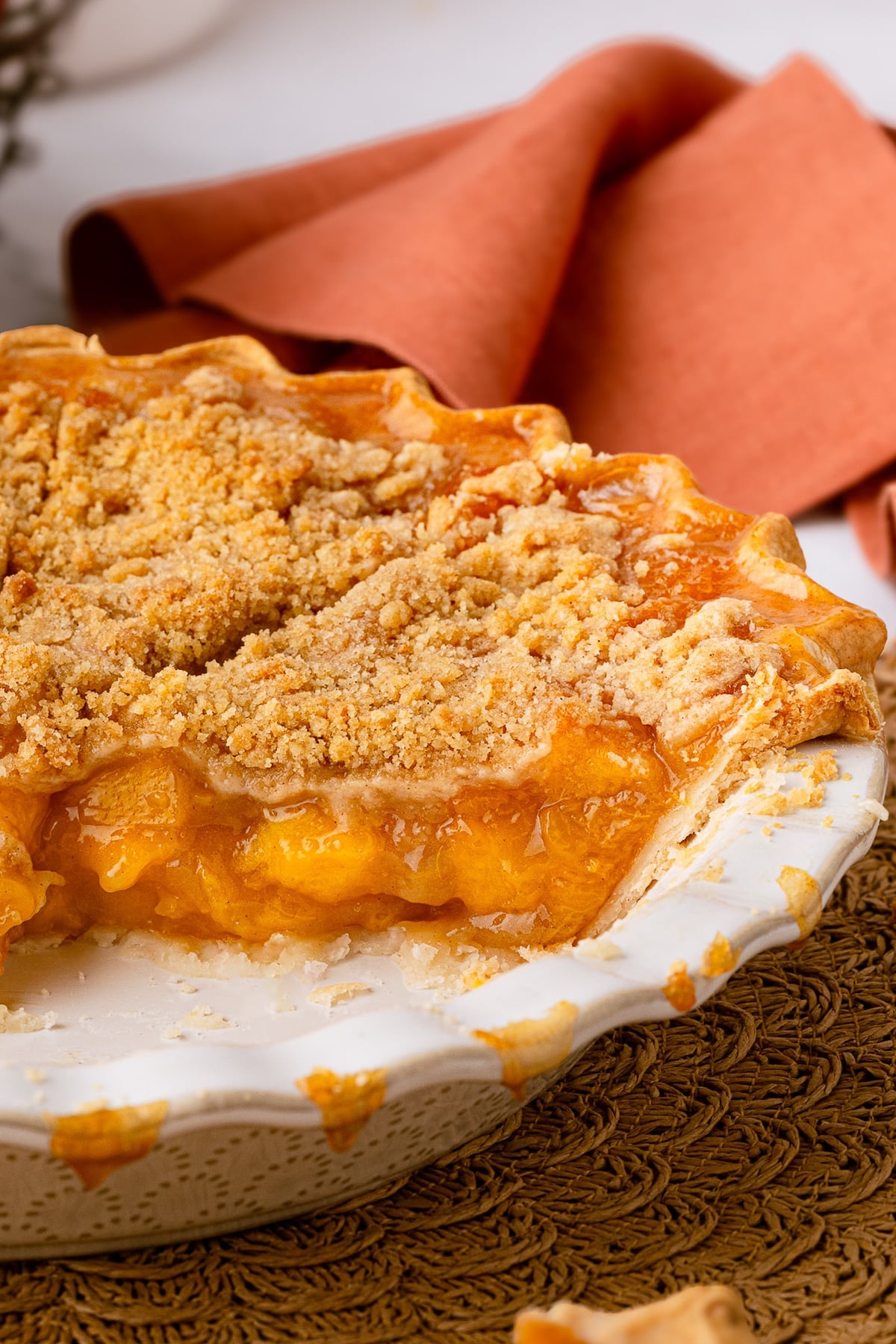A deep dish peach pie made with frozen sliced peaches.