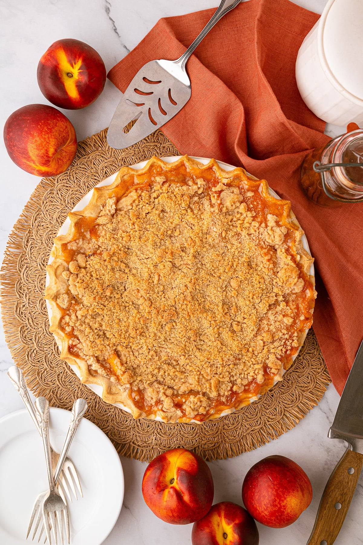 A freshly baked deep-dish peach pie made with frozen peaches, cooling for a perfectly set fruit filling.
