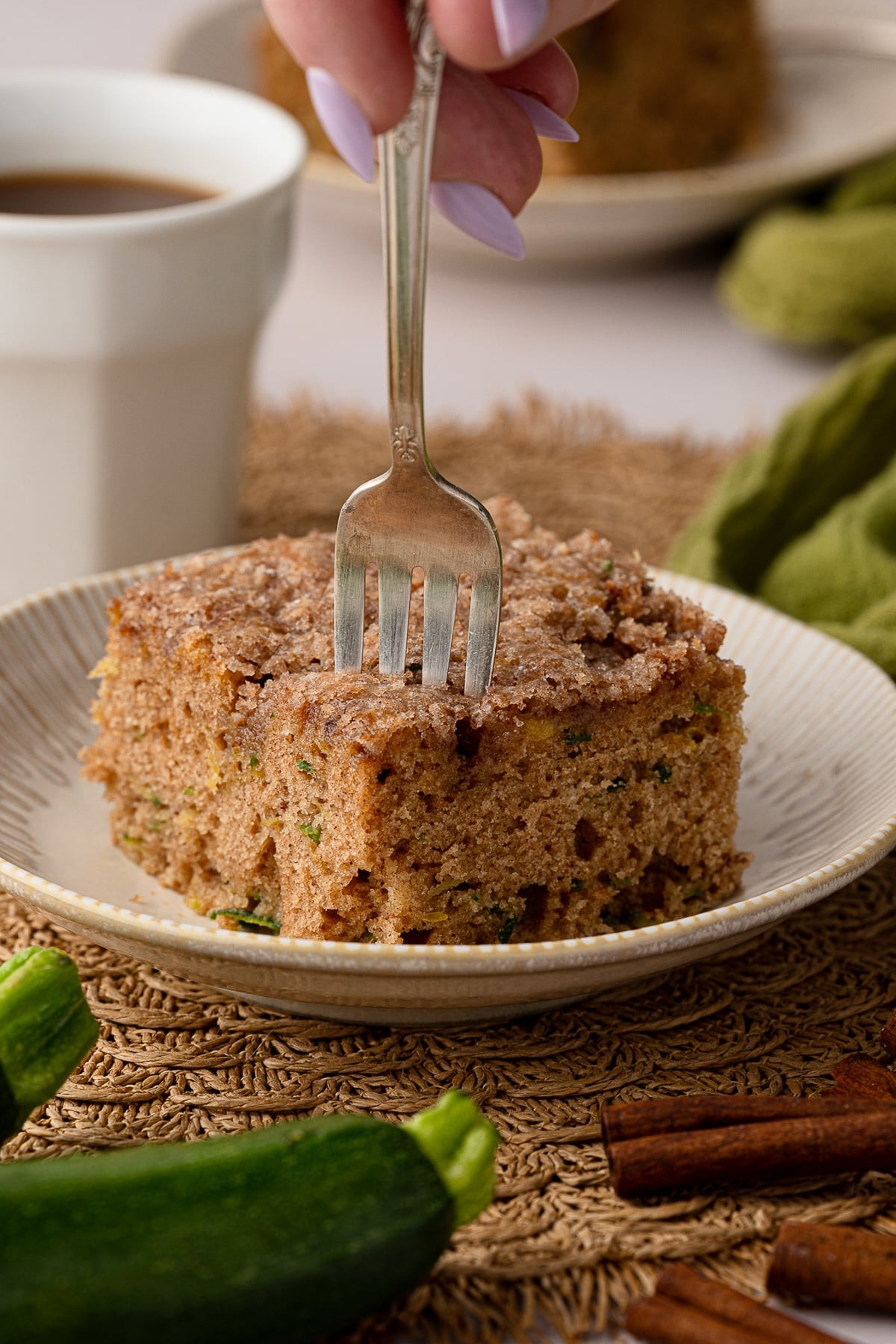 A fork taking a bite of the delicious cake that is perfect for using leftover grated zucchini.