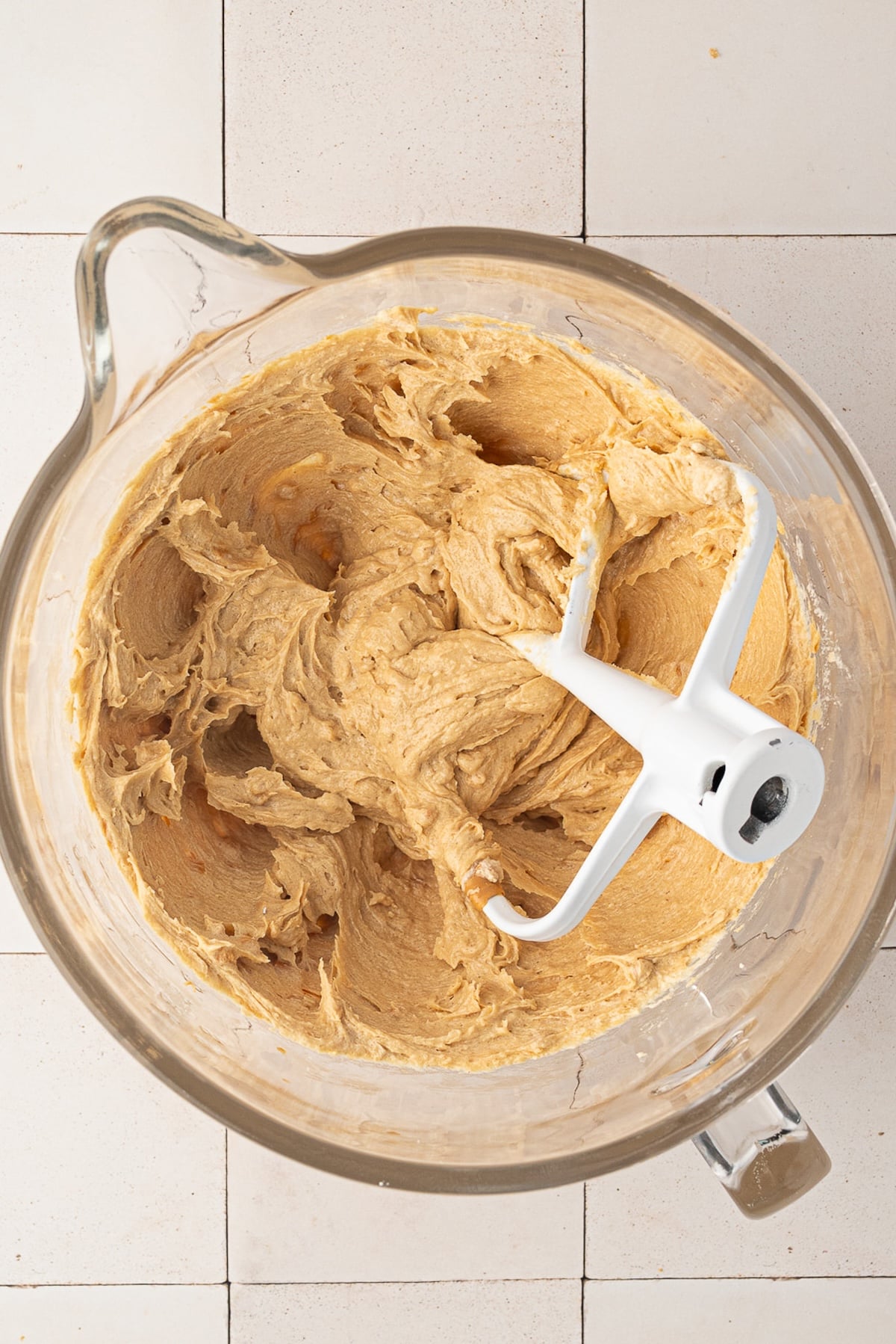 Creamy texture of beaten butter, peanut butter, and sugars for making peanut butter cookie dough.