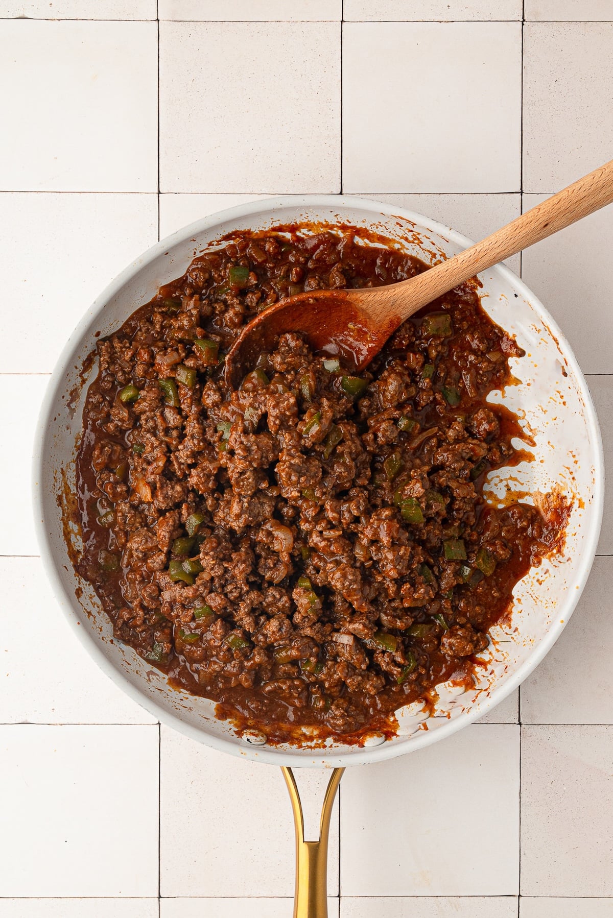 Simmering thick, glossy sloppy joe meat sauce in a large skillet.