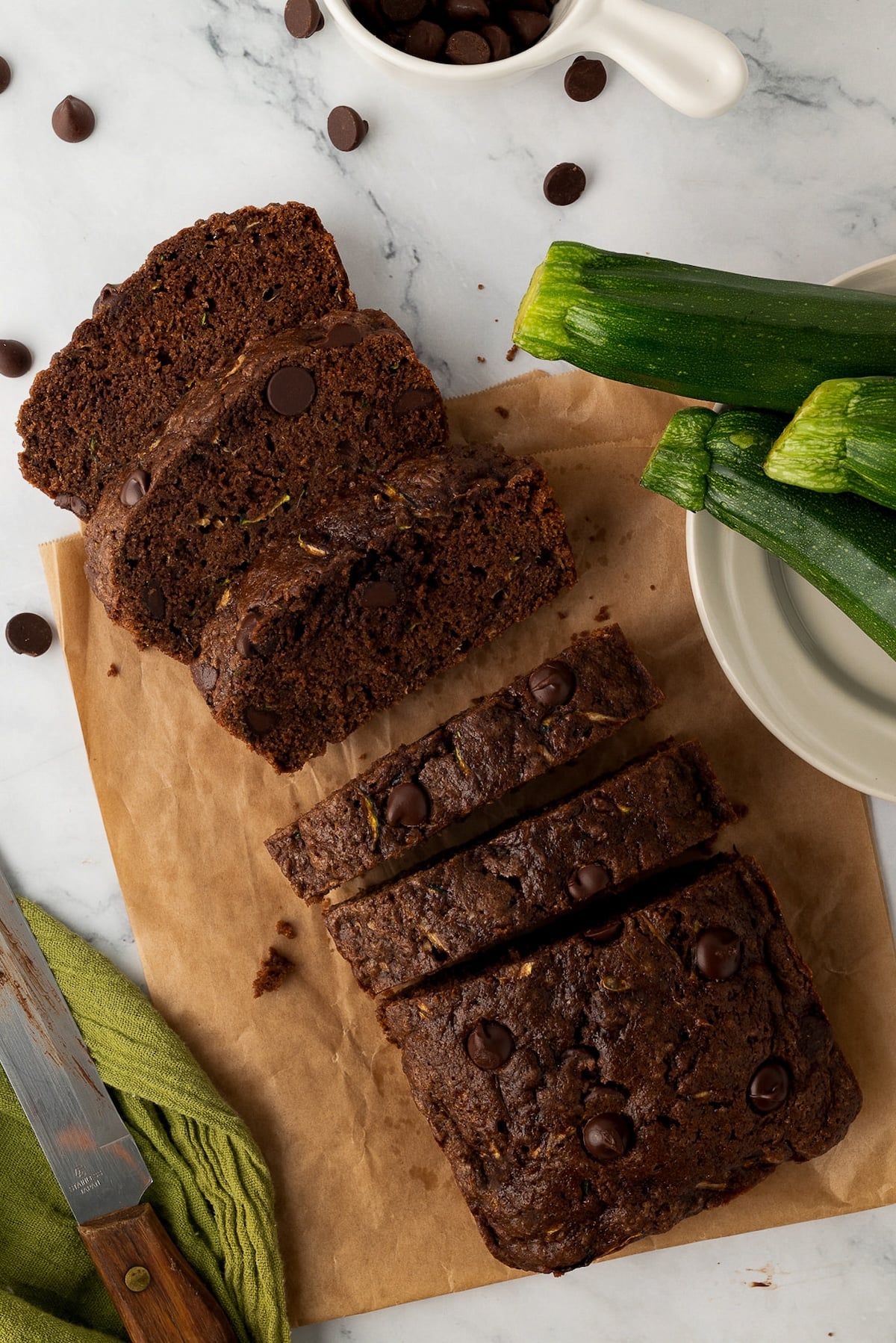 Chocolate zucchini bread sliced on a counter, showing the tender chocolate crumb and chocolate chips.
