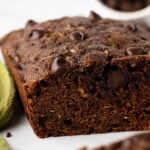 Close-up of sliced chocolate zucchini bread showing the moist chocolate crumb and chocolate chips.