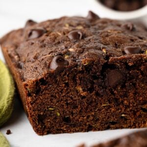 Close-up of sliced chocolate zucchini bread showing the moist chocolate crumb and chocolate chips.