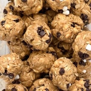 Closeup of round no-bake s'mores protein bites showing texture from oats, peanut butter, marshmallows and chocolate chips.