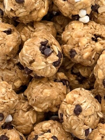 Closeup of round no-bake s'mores protein bites showing texture from oats, peanut butter, marshmallows and chocolate chips.